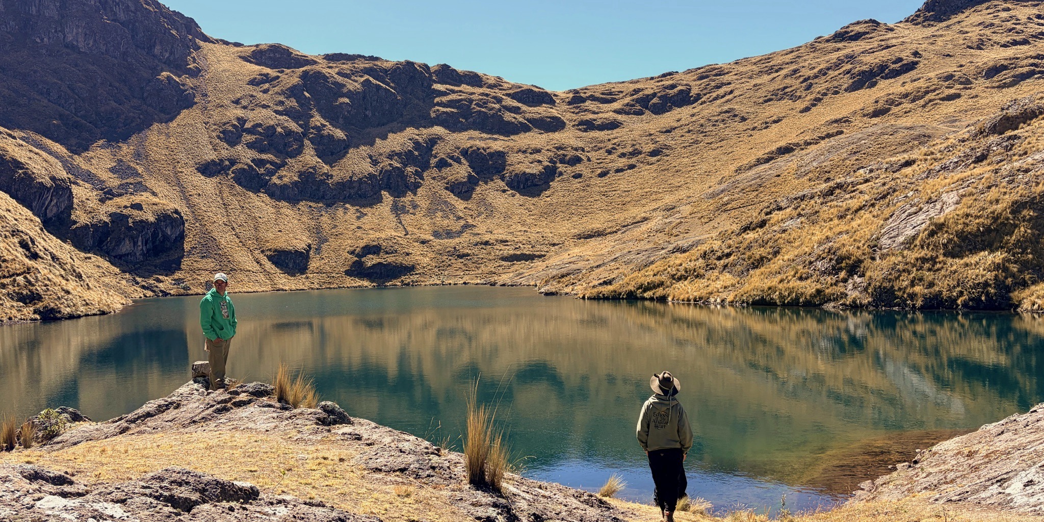 A still lake held in a bowl of high peaks.